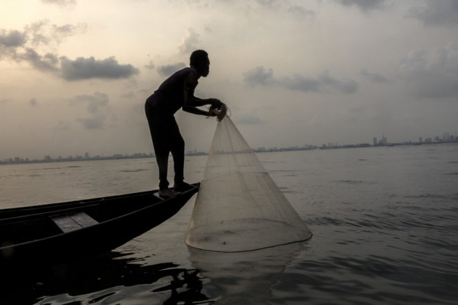 Fisherman catching fish in Lagos lagoon, Nigeria