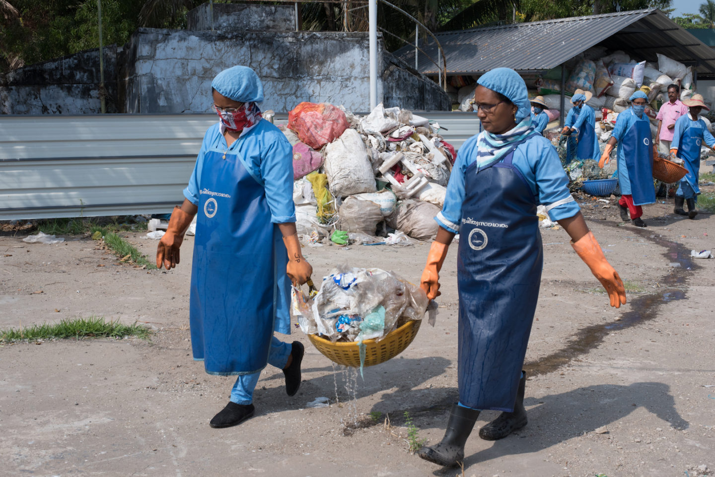 Clean Seas staff move washed marine waste for drying, to be used to make plastic roads in india