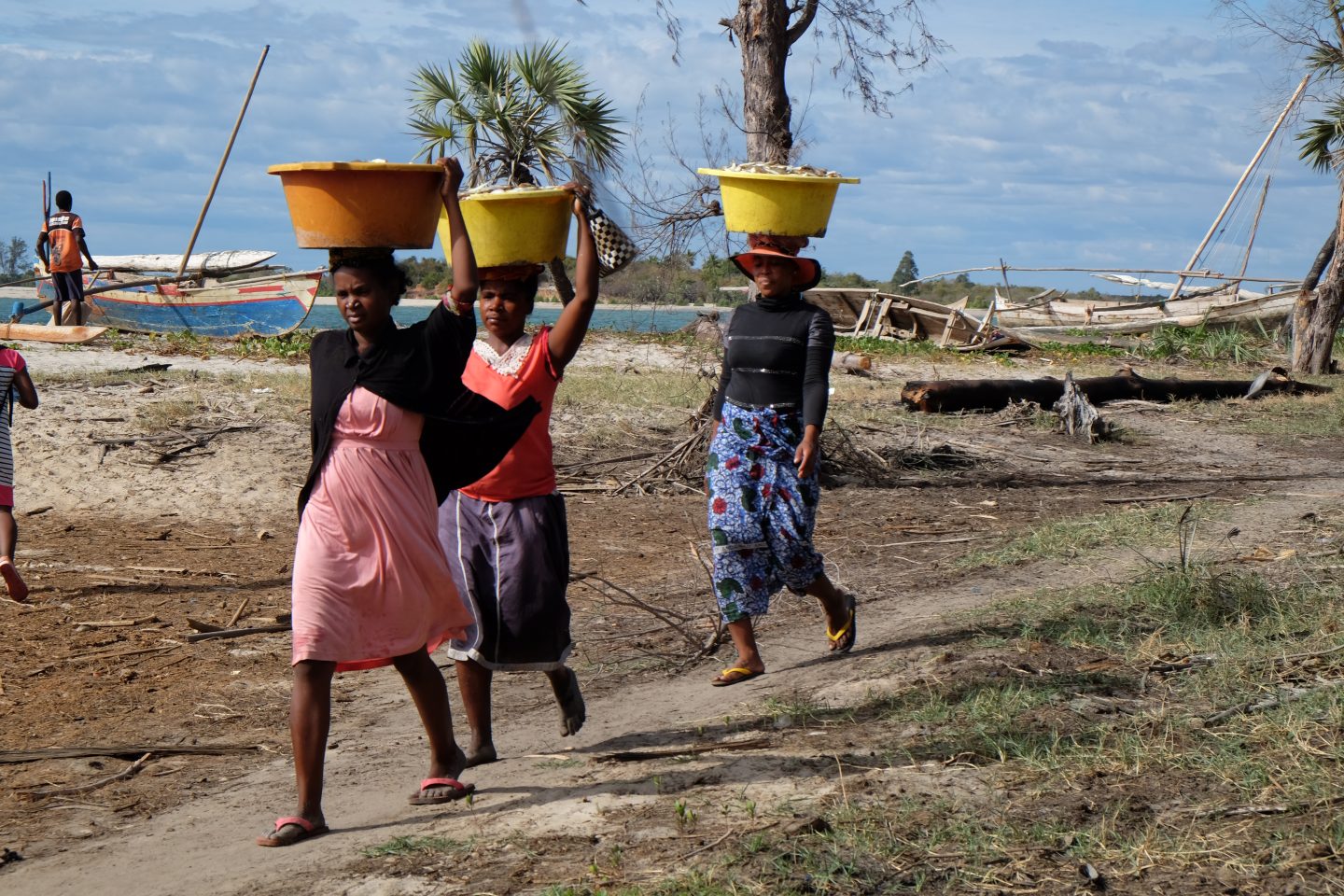 Madagascan women bring a fish catch into their village