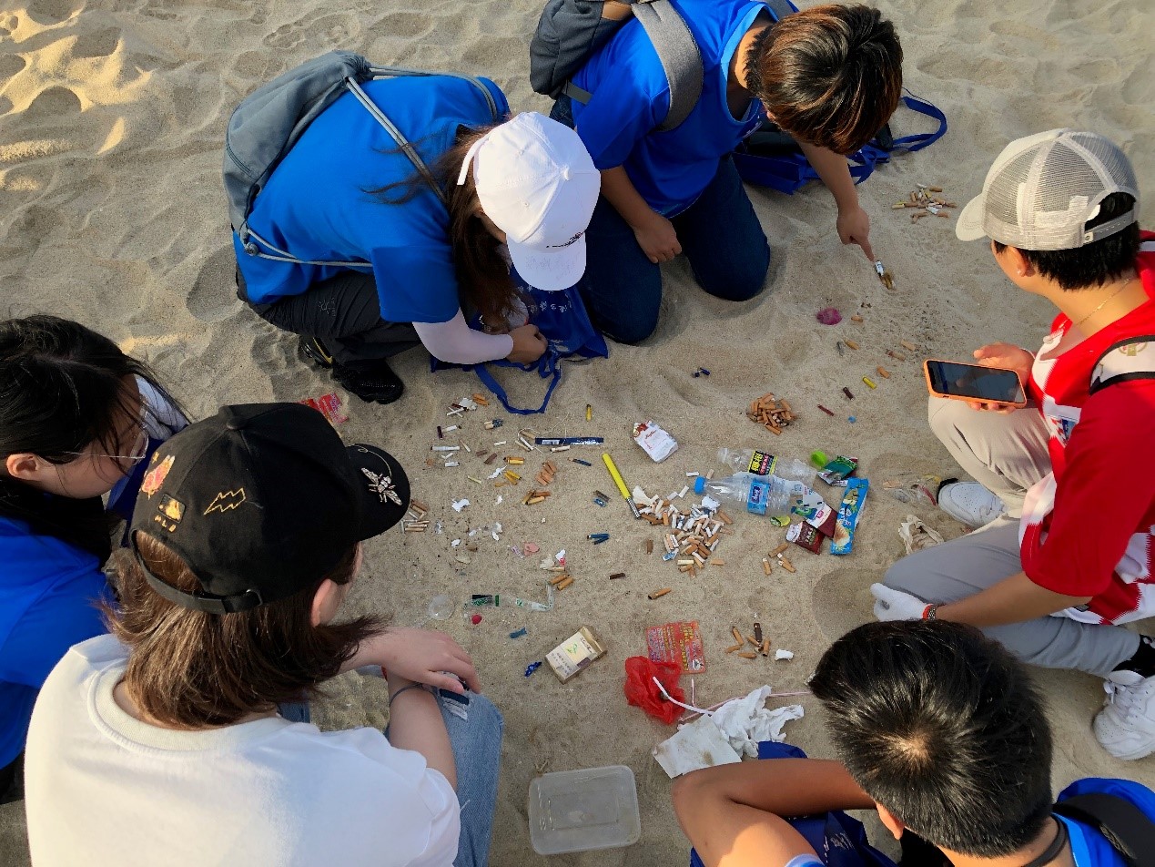 Volunteers collect and sort litter on Sanya beach, Hainan island 
