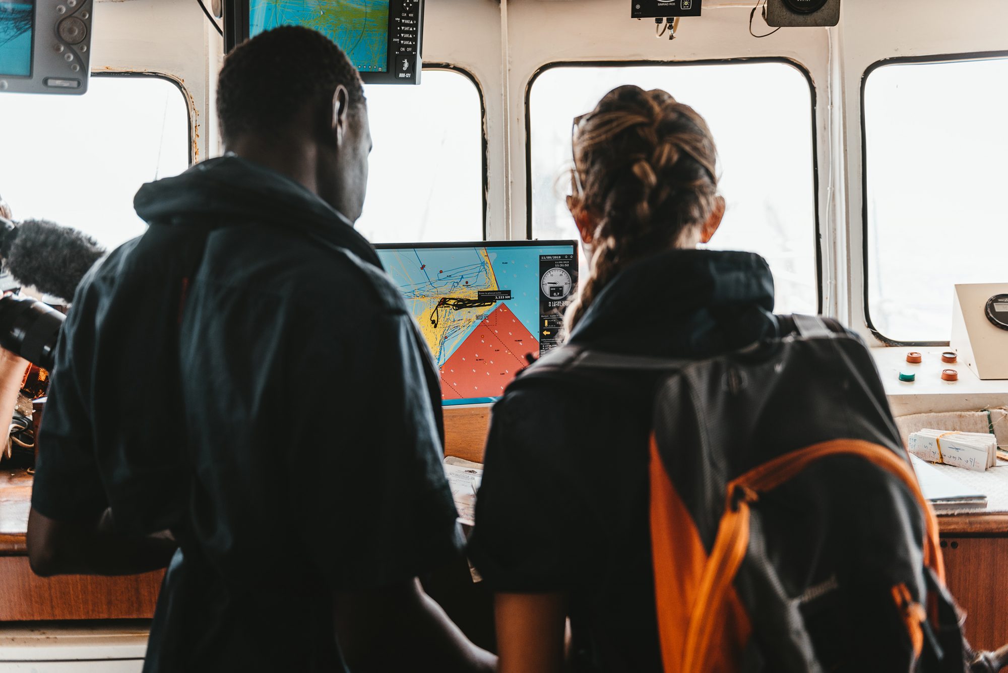 A Gambian fisheries inspector on board the Sea Shepherd’s Sam Simon reviews the track history of a trawler fishing illegally in Gambian waters (Image © Flavio Gasperini / Sea Shepherd)