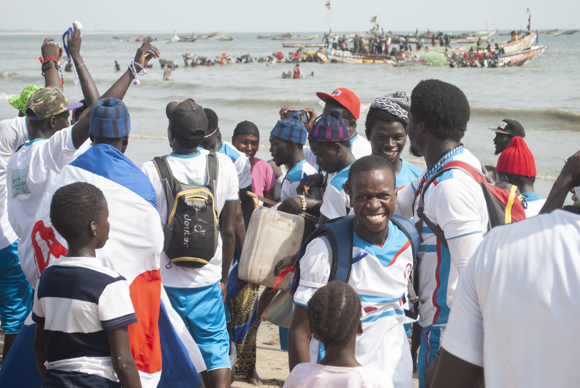 A group of Senegalese fishers celebrate on Gunjur beach in the Gambia. They have just completed their six-month contract to supply fish to the Golden Lead factory, and are now returning to Senegal. (Image: Mustapha Manneh / China Dialogue)
