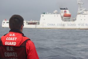 <p>A crew member of the USCGC Alex Haley (WMEC 39) stands lookout during a transfer of custody of the detained fishing vessel Run Da in the Sea of Japan, June 21, 2018. (Image: <a href="https://www.flickr.com/photos/coastguardnews/42907938492/in/album-72157669658271038/">US Coast Guard</a>)</p>