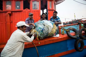 <p>The crew of Holy Star with litter recovered from their nets, Sakthikulangara harbour, Kerala. (Image: Shailendra Yashwant)</p>