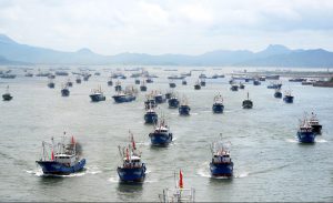 <p>A fishing fleet departs harbour after the summer fishing moratorium in Zhoushan, Zhejiang province (Image: Alamy)</p>