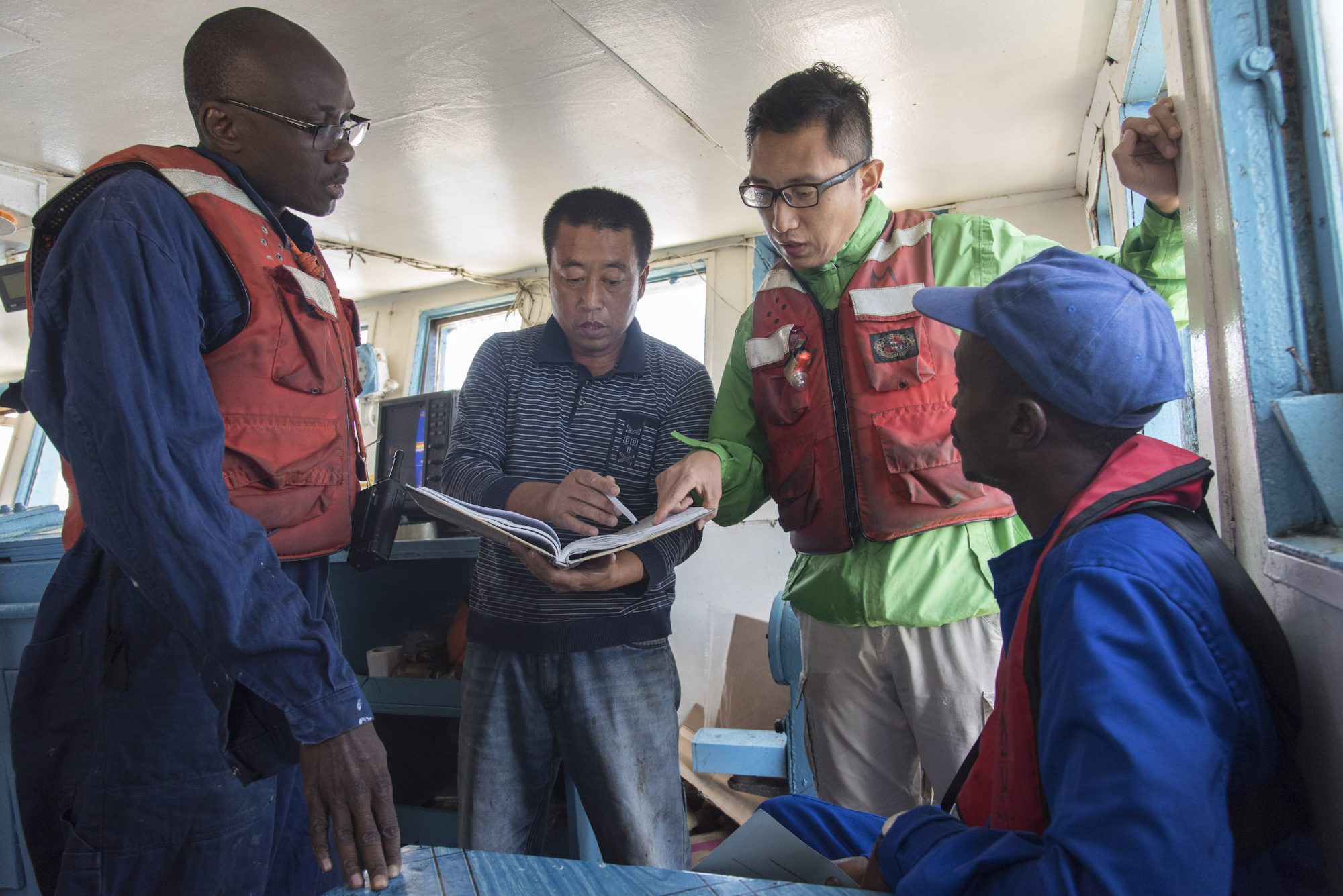 fisheries observers on bridge of Senegalese / Chinese fishing boat