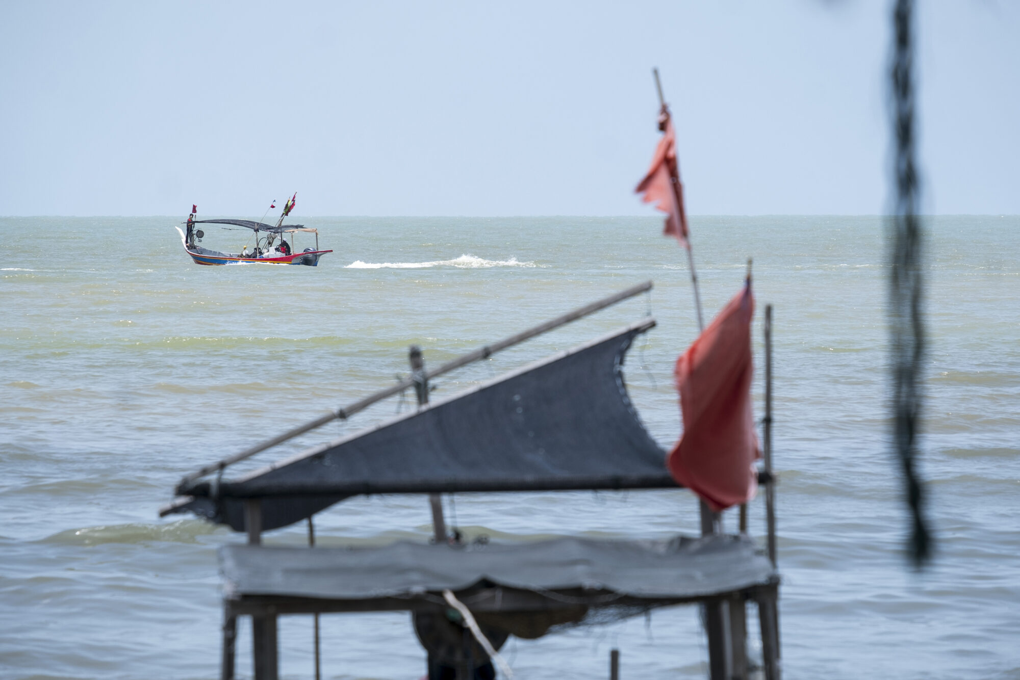 A fishermen boat is out at sea in a bay in the southern part of the Penang island.