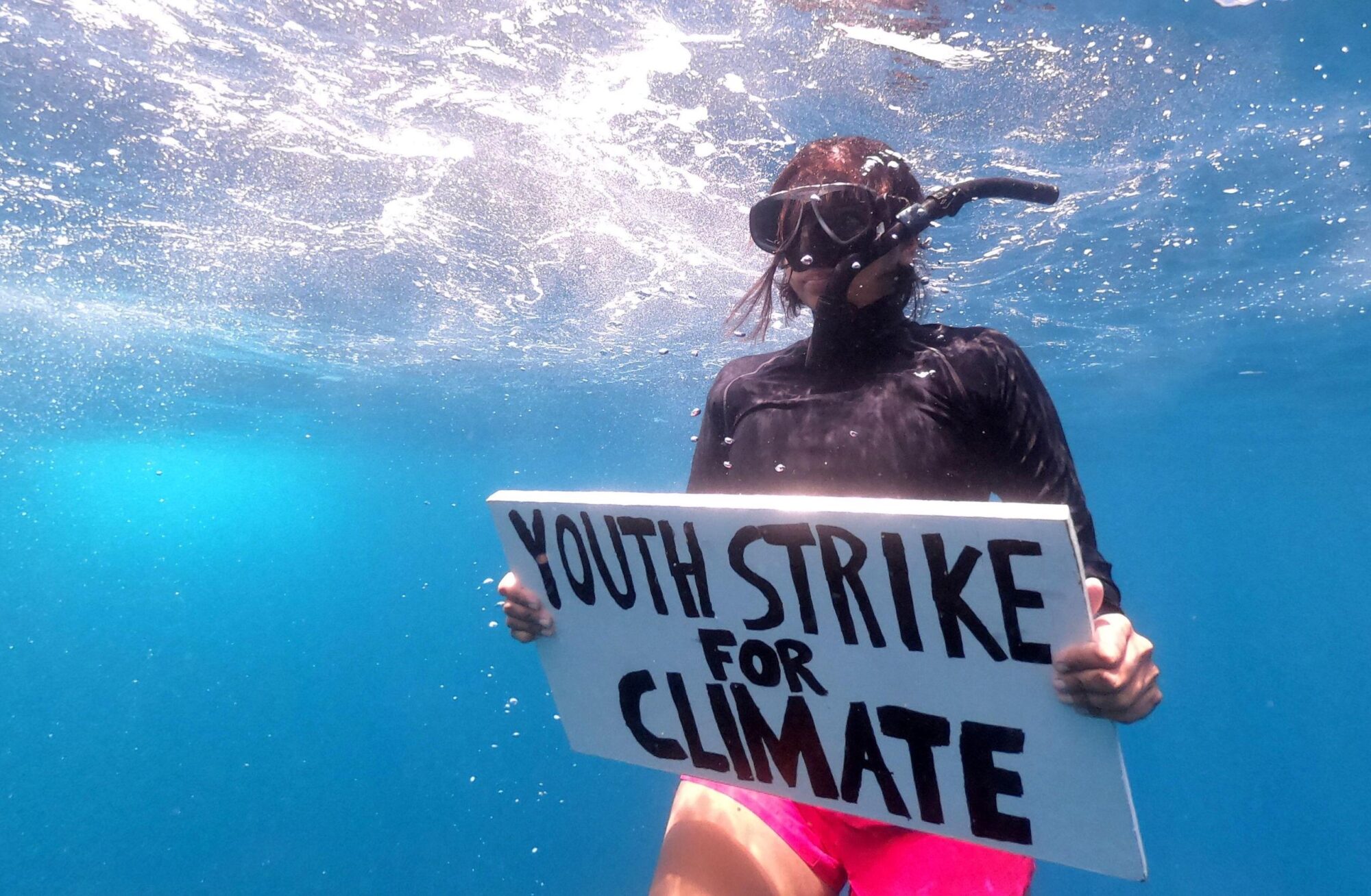 Mauritian scientist and climate change activist Shaama Sandooyea 24, holds a placard reading Youth Strike For Climate, during an underwater protest at the Saya de Malha Bank to highlight the need to protect the world's largest seagrass meadow