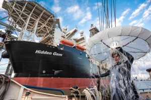 <p>A protestor beside the Hidden Gem, which in September became the first ship authorised by the ISA to test its mining equipment, in the Clarion-Clipperton Zone (Image: Charles M. Vella / Alamy)</p>